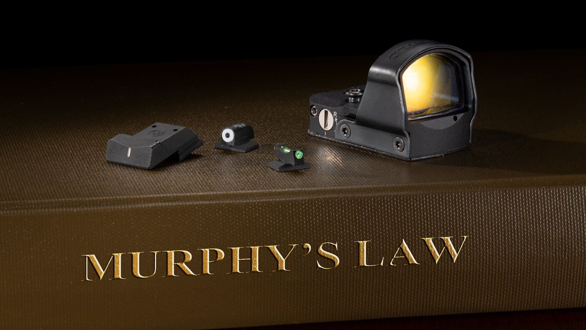 handgun sight on murphy's law book