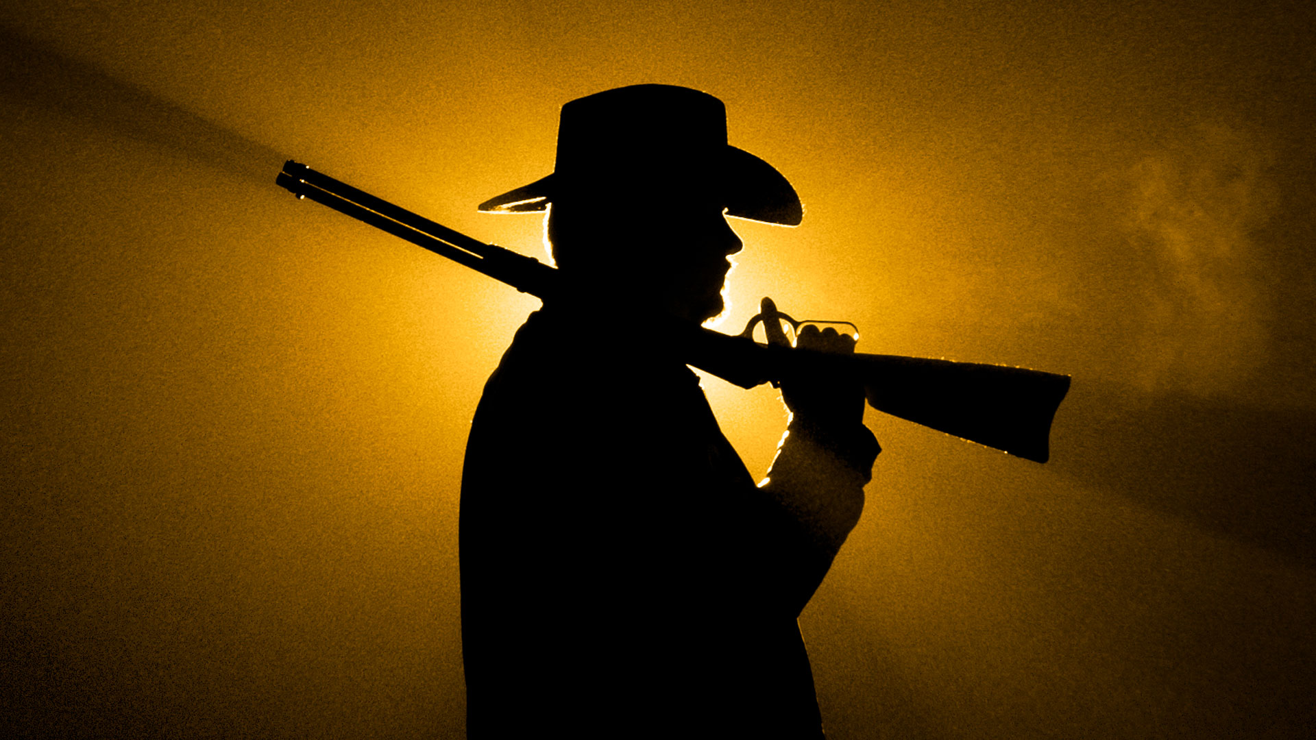 silhouette of man with rifle