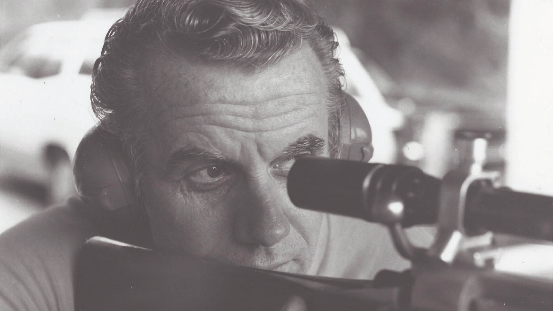 man looking through riflescope