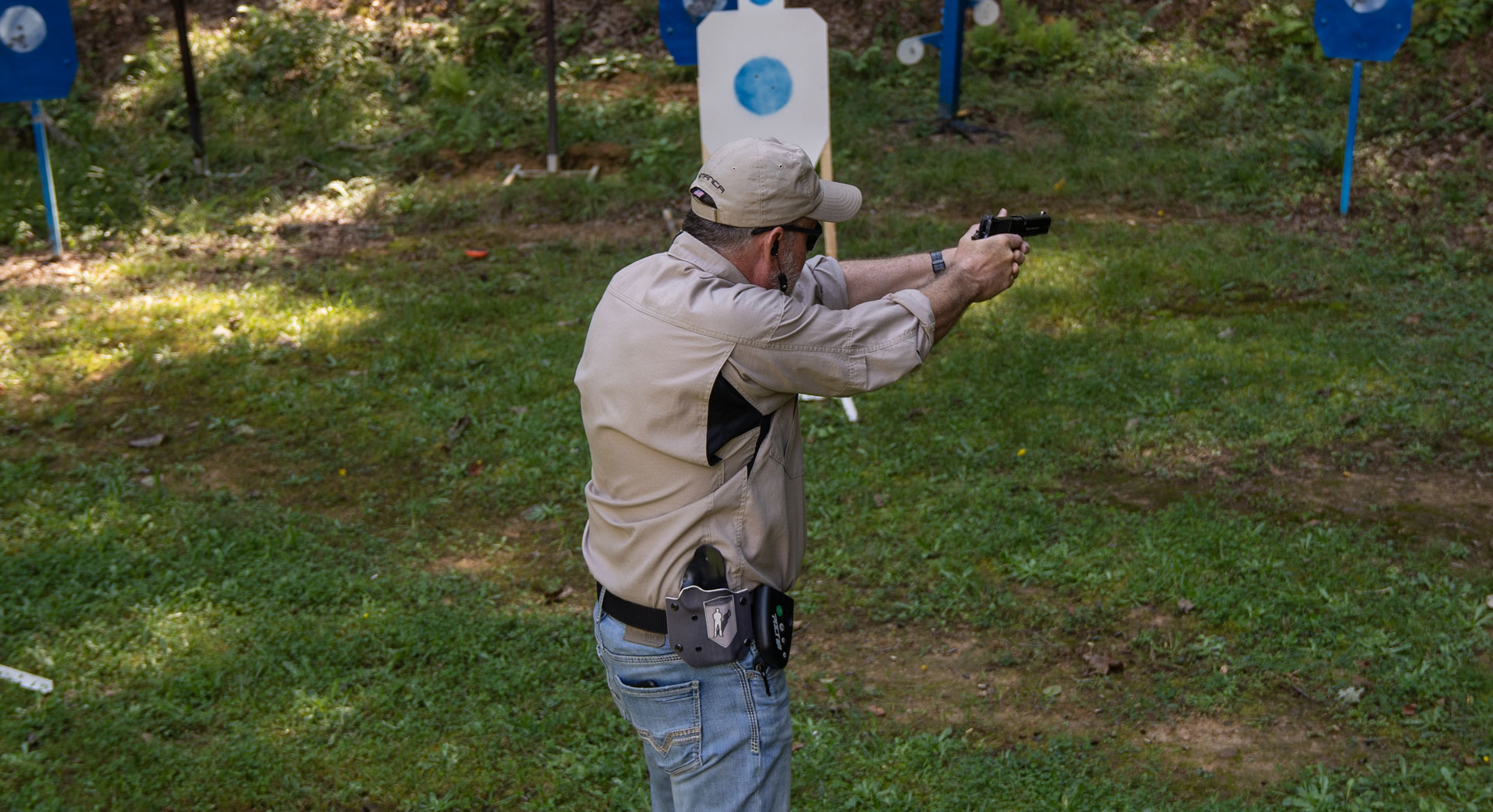 man firing at steel targets