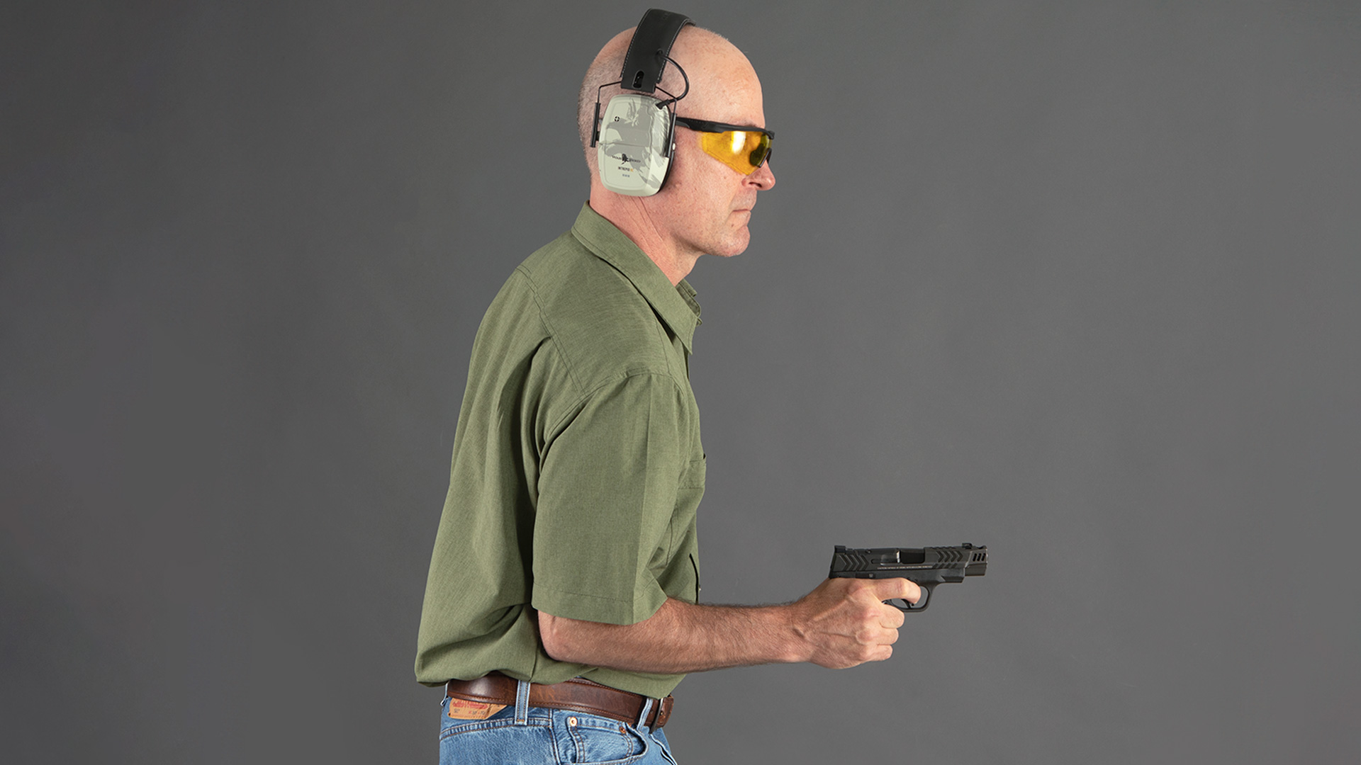 man holding firearm at his hip