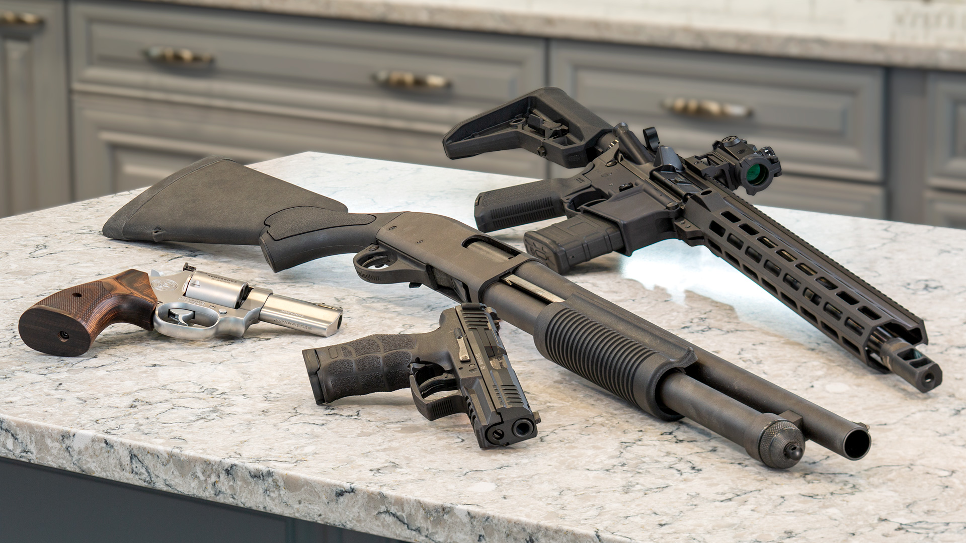variety of firearms on a table